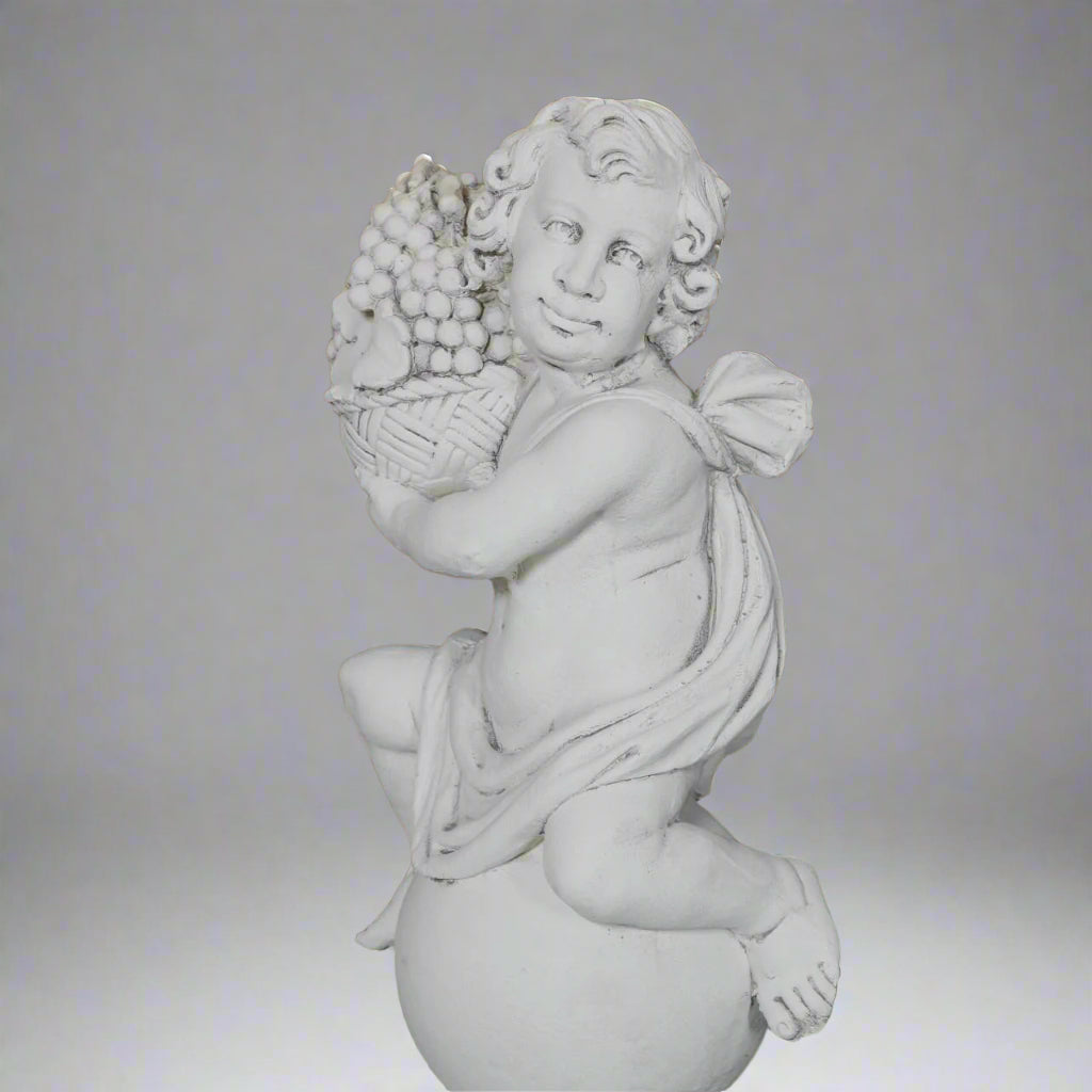 Close-up of Autumn cherub statue holding a basket of grapes from the Four Seasons Stone Statues, ideal for seasonal garden sculpture displays.