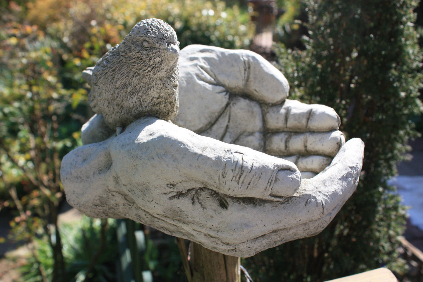 Close-up of Bird Bath/Feeder - Stone Hands Design with Durable Finish, highlighting intricate hand and bird sculpture for garden decoration.