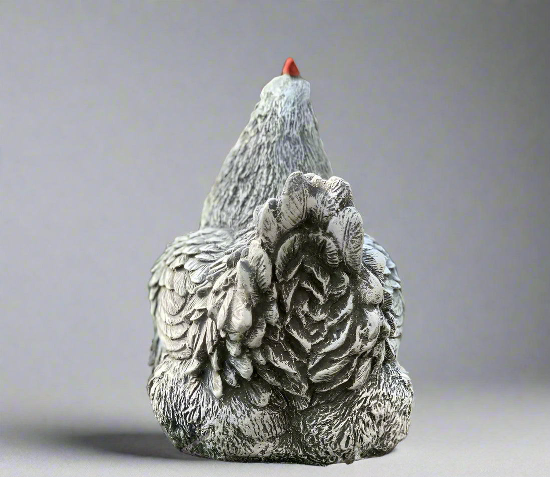 Rear view of stone chicken statue for garden décor, highlighting intricate tail feather design and solid outdoor construction.