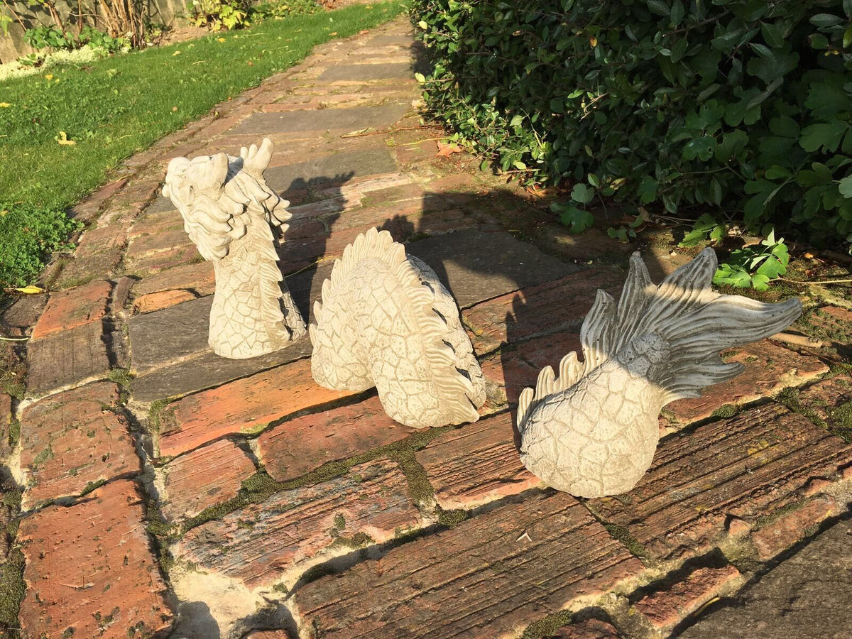 Elegant Garden Decor featuring Chinese Dragon Stone Ornament with detailed tail and body segments arranged on a sunlit brick path.