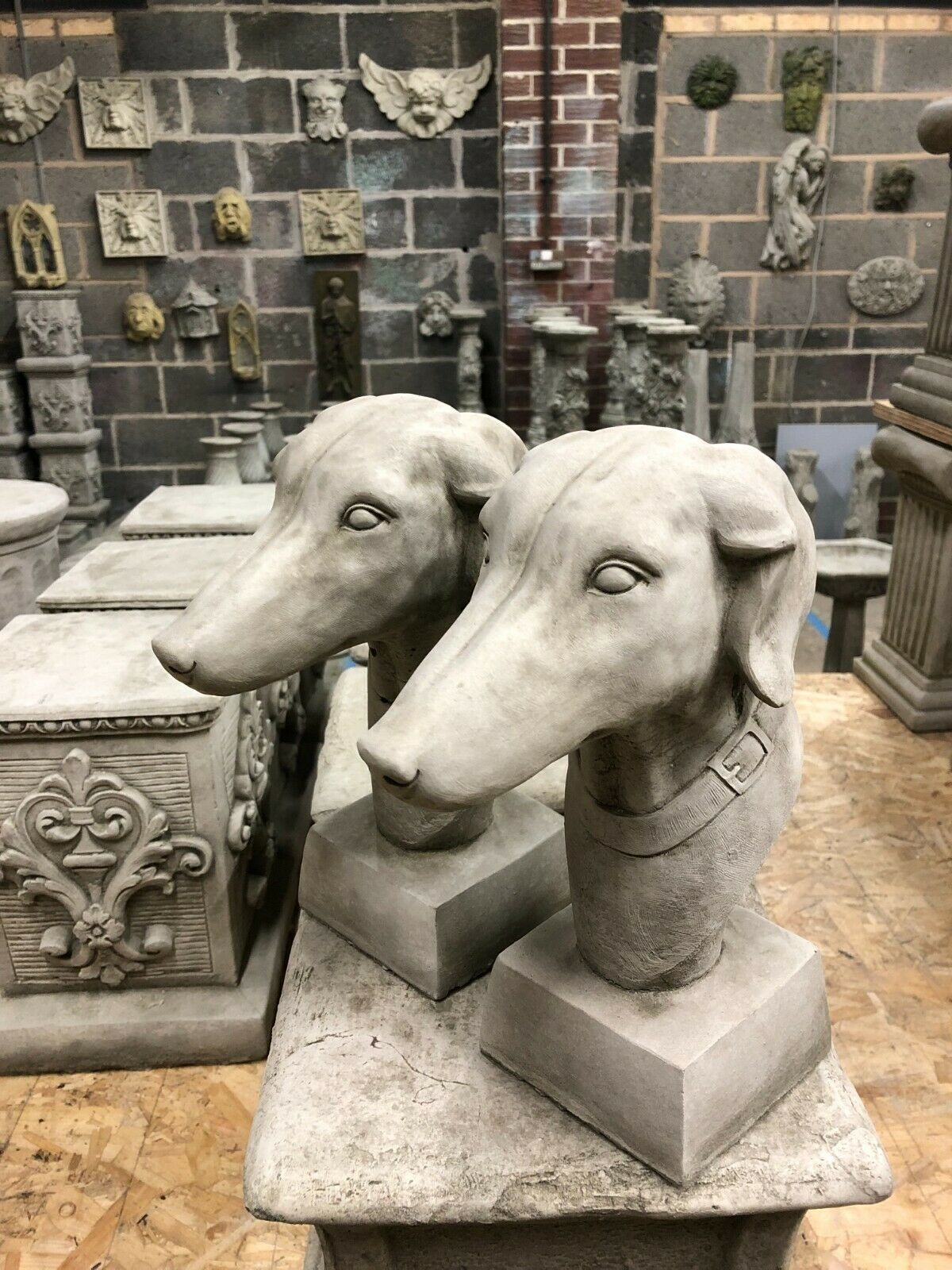 Detailed busts of Stone Greyhound Finials with antique finish, ideal for enhancing garden decor or home exterior pillars.