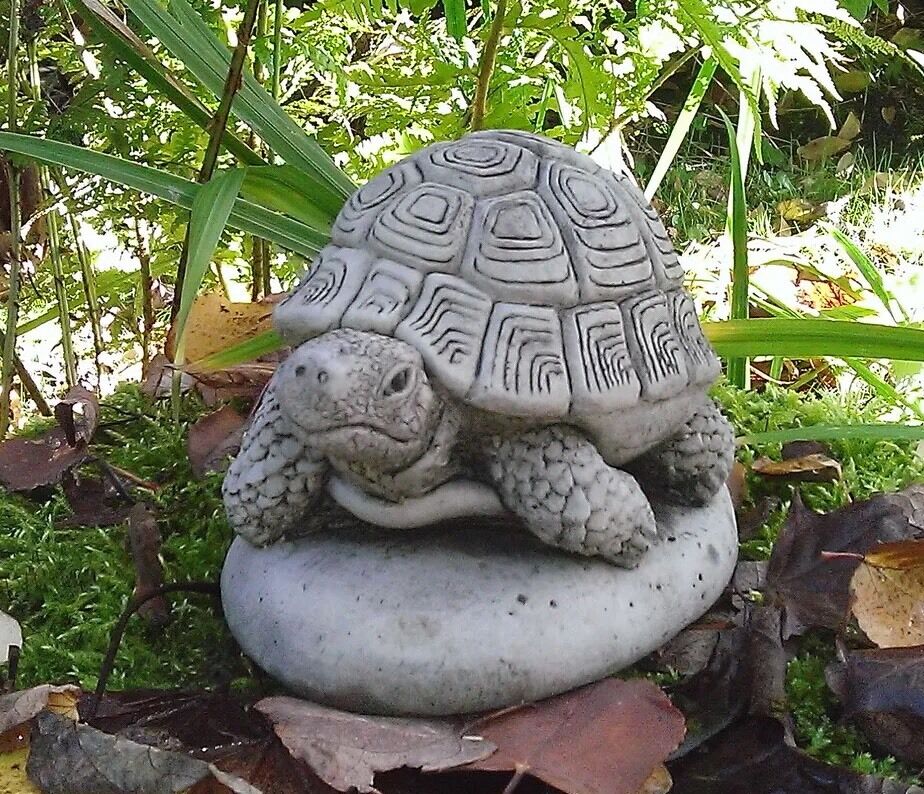 Stone Tortoise Garden Ornament with antique grey finish resting on a stone base, ideal for enhancing outdoor garden aesthetics year-round.