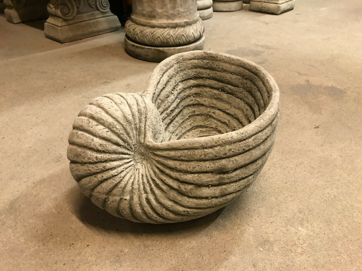 Side angle of Antique Grey Stone Shell Design Garden Planter Pot with weathered limestone finish, ideal for patios and garden spaces.
