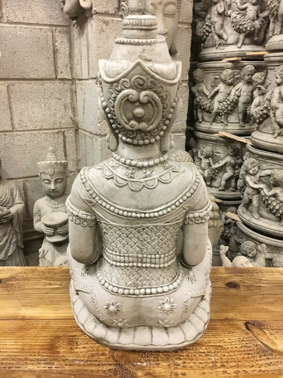 Rear view of Peaceful Stone Buddha Statue showing detailed carvings and traditional attire, crafted for outdoor garden decoration.