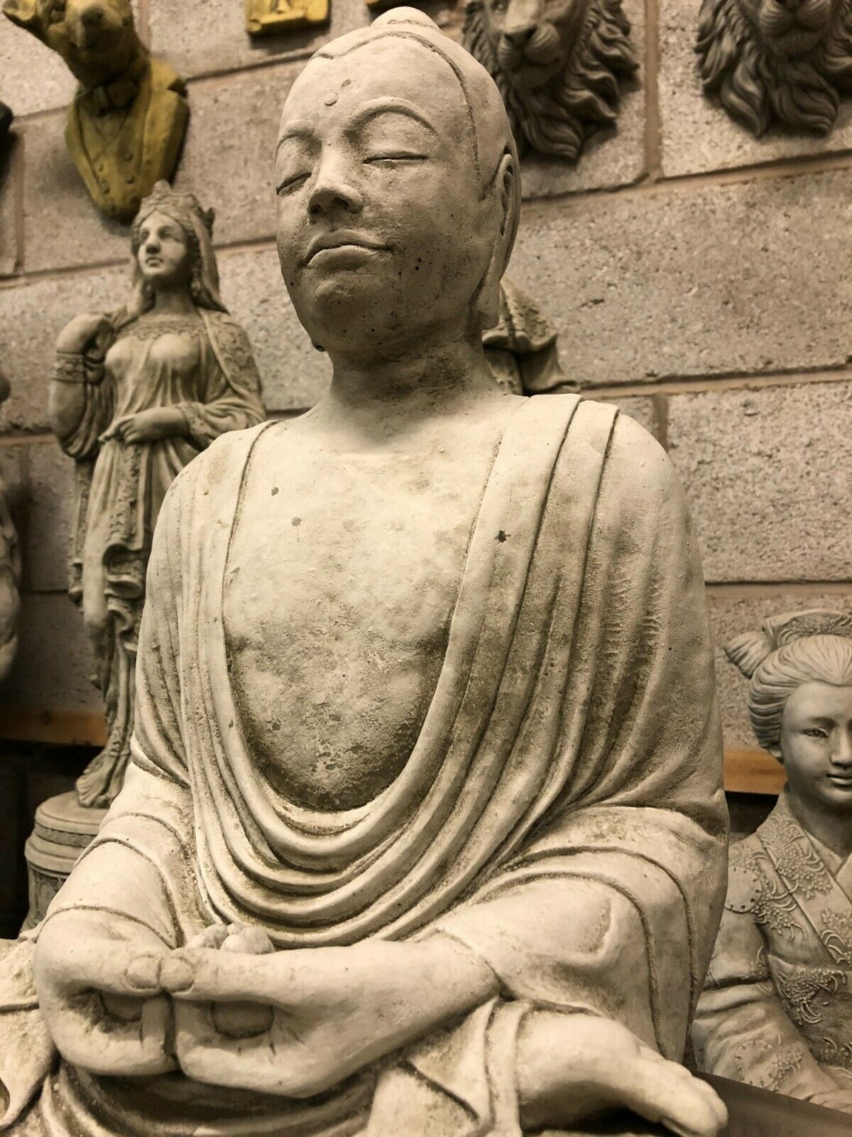 Close-up of Stone Mudra of Meditation Buddha Statue showing serene facial features and intricate craftsmanship, ideal for garden serenity.