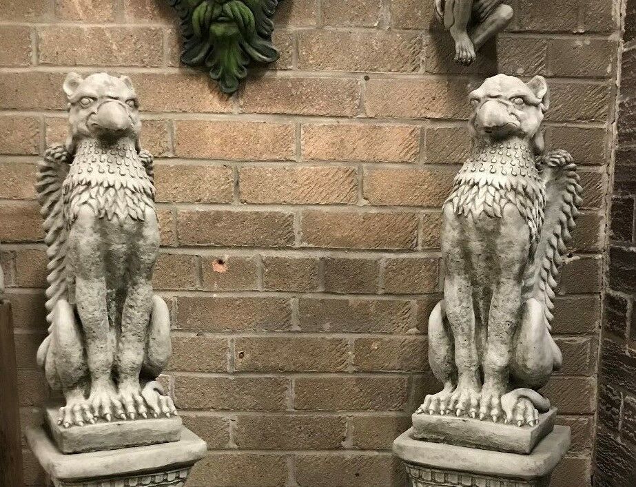 Outdoor Stone Statues - Phoenix Garden Statues featuring a pair of weather-proof, heavy stone griffin-style guardians on plinths for garden decor.