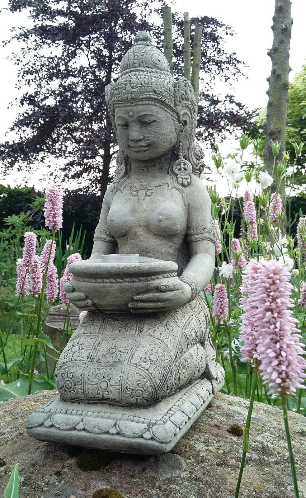 Geisha Statue Candle Holder in a peaceful garden setting, holding a tealight, crafted from stone for elegant outdoor garden decor.