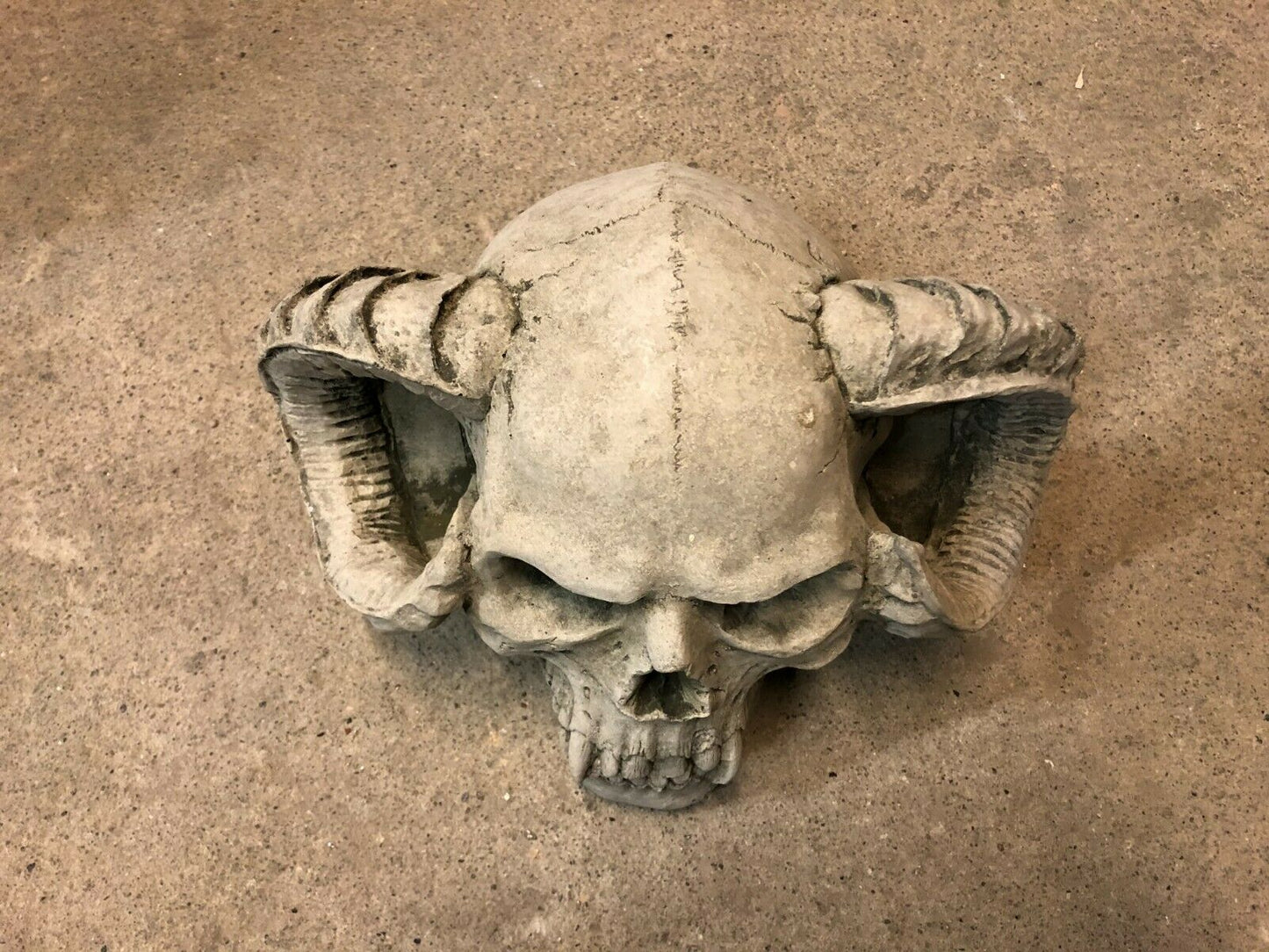 Top view of Skull Horn Design Ornament showing detailed horn curvature and antique stone finish, ideal for gothic outdoor decor.