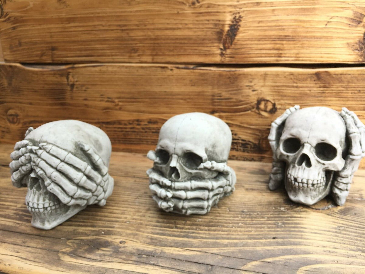 Full set of three stone skull garden ornaments—Hear, See & Speak No Evil—crafted from limestone with gothic design for home and garden decor.
