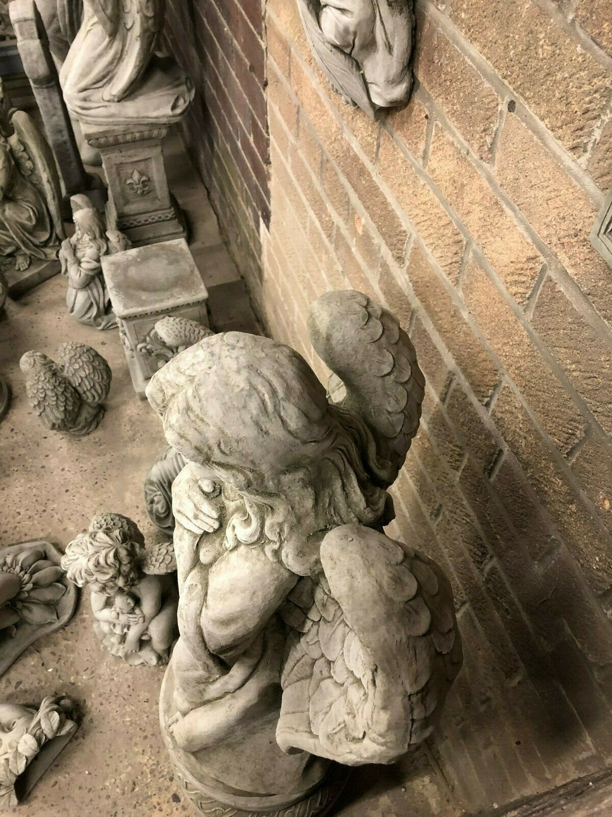 Top view of weather-resistant stone angel statue showing detailed wing craftsmanship, suitable for outdoor garden sculpture.