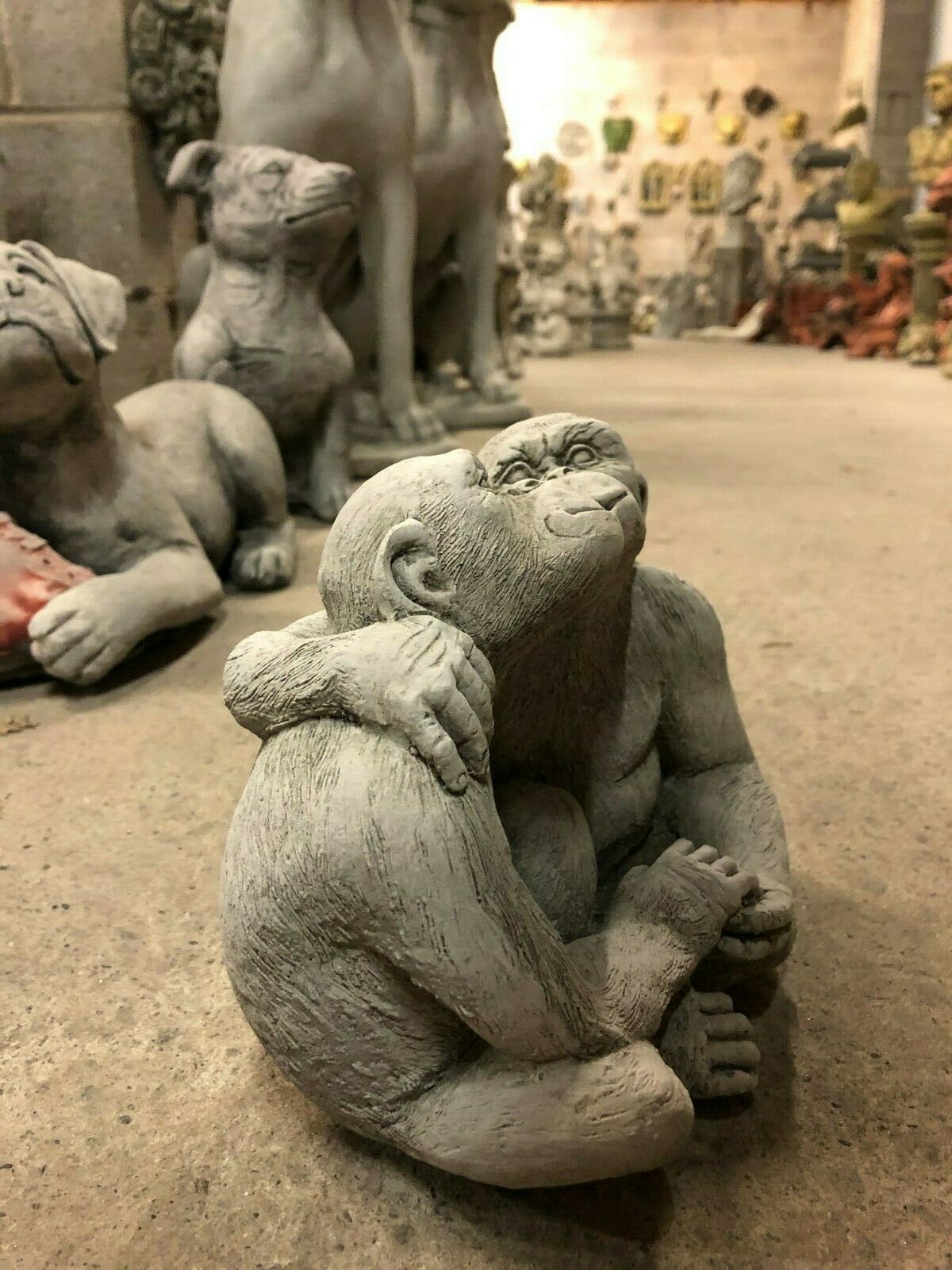 Angled view of Garden Stone Monkey Ornament - Kissing Couple, showcasing detailed limestone texture for home and garden.