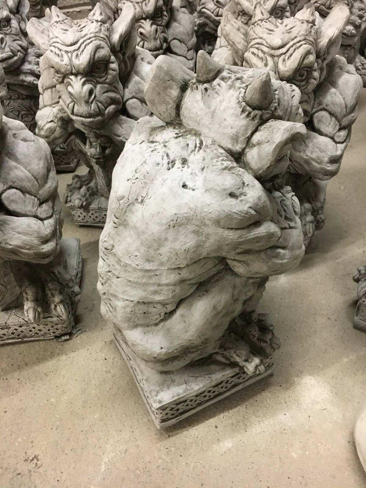 Side view of a stone gargoyle statue showing muscular back and detailed base, designed for fantasy-themed garden decoration.