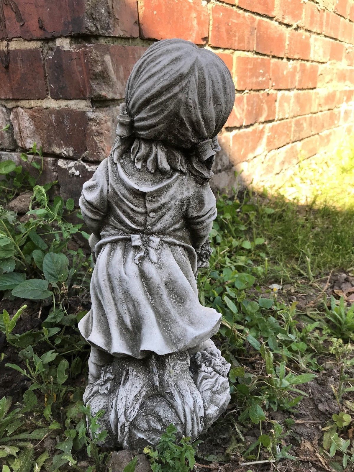 Rear view of the Stone Basket Girl Garden Planter Ornament highlighting the sculpted dress and hair, suitable for outdoor garden decor.