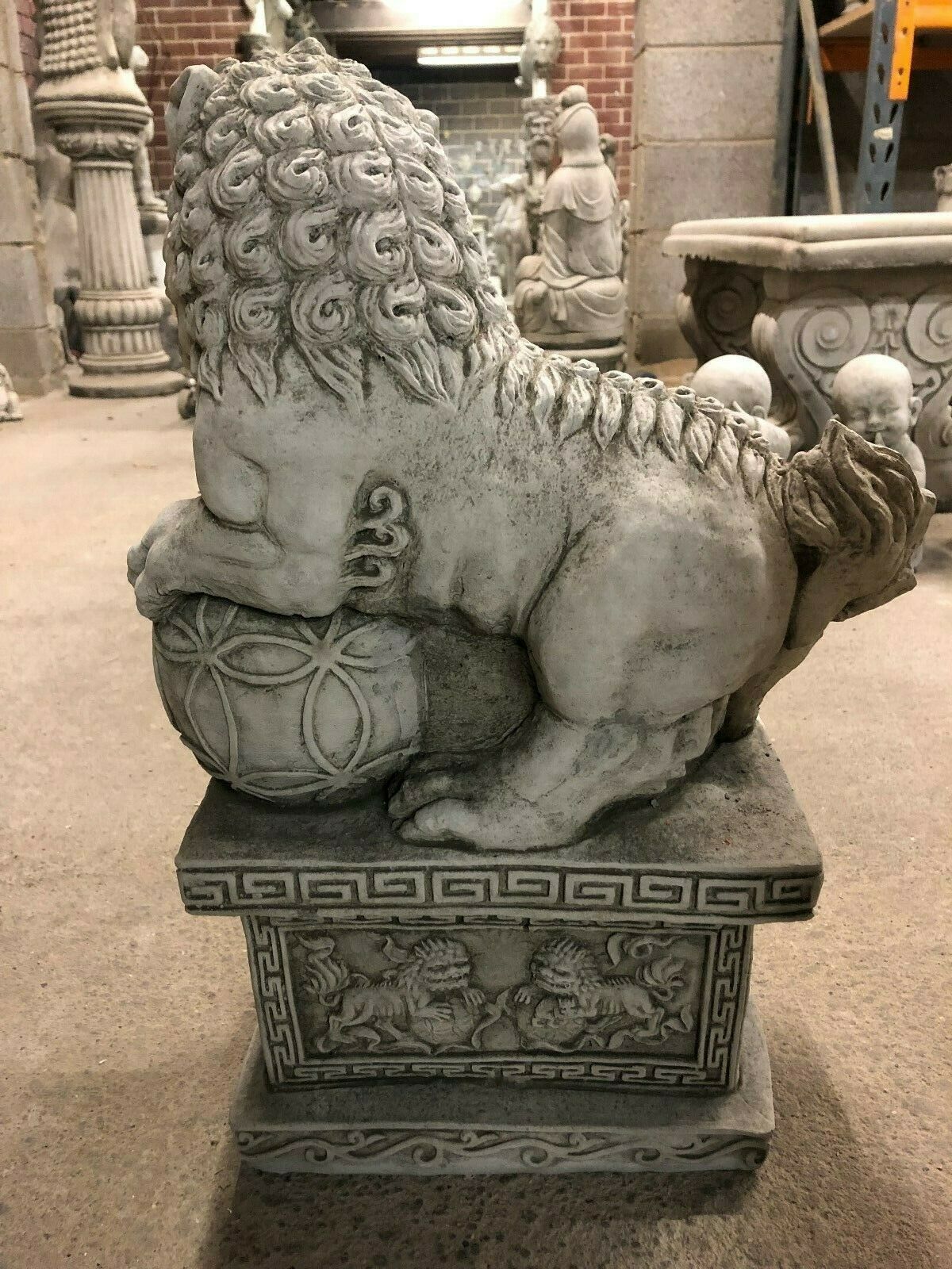 Side profile of Foo Dog Statue with intricate ball and base engravings, ideal for enhancing home or garden aesthetics.