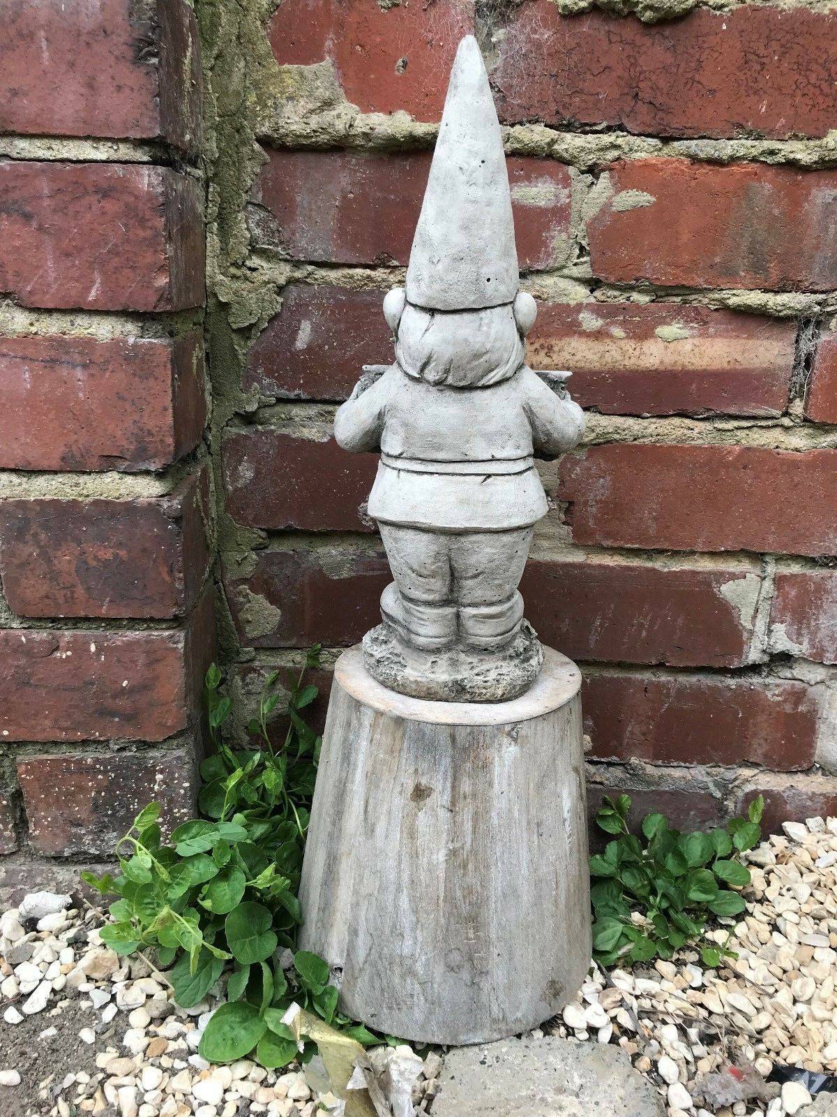 Rear view of the Grumpy Garden Gnome ornament, highlighting full 360-degree stone sculpture detail for outdoor garden display.