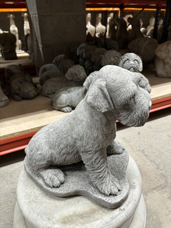 Angled side profile of the Stone Schnauzer Garden Statue, highlighting detailed fur texture and sturdy limestone build for outdoor use.