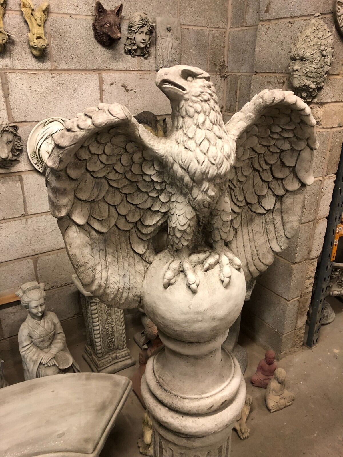 Close-up of eagle statue's face and wings, crafted from solid limestone, offering a bold and majestic garden focal point.