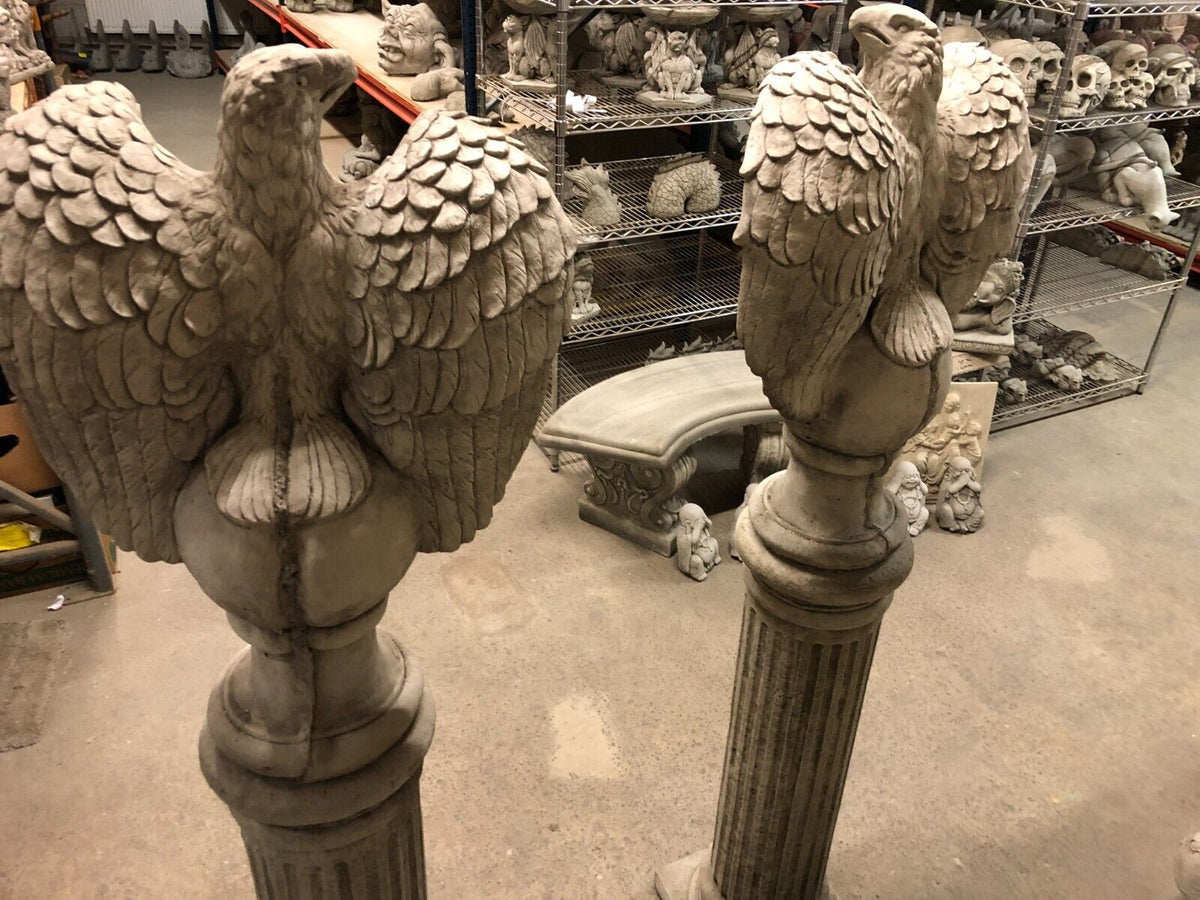 Top-down view of limestone eagle statues on pedestals, highlighting the textured stone craftsmanship for premium outdoor decoration.
