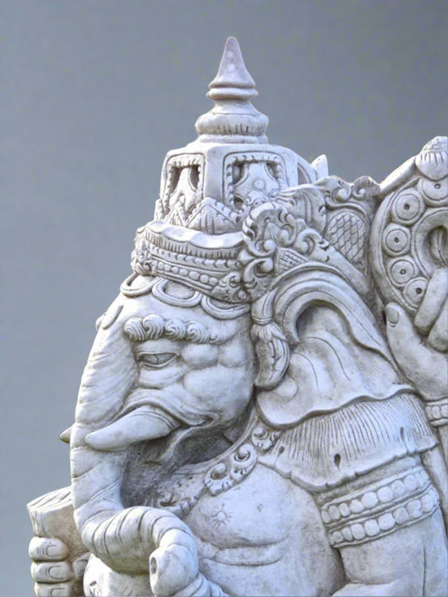 Close-up of Ganesh statue's ornate crown and facial features, highlighting the fine hand-carved stone details and spiritual symbolism for home decor.