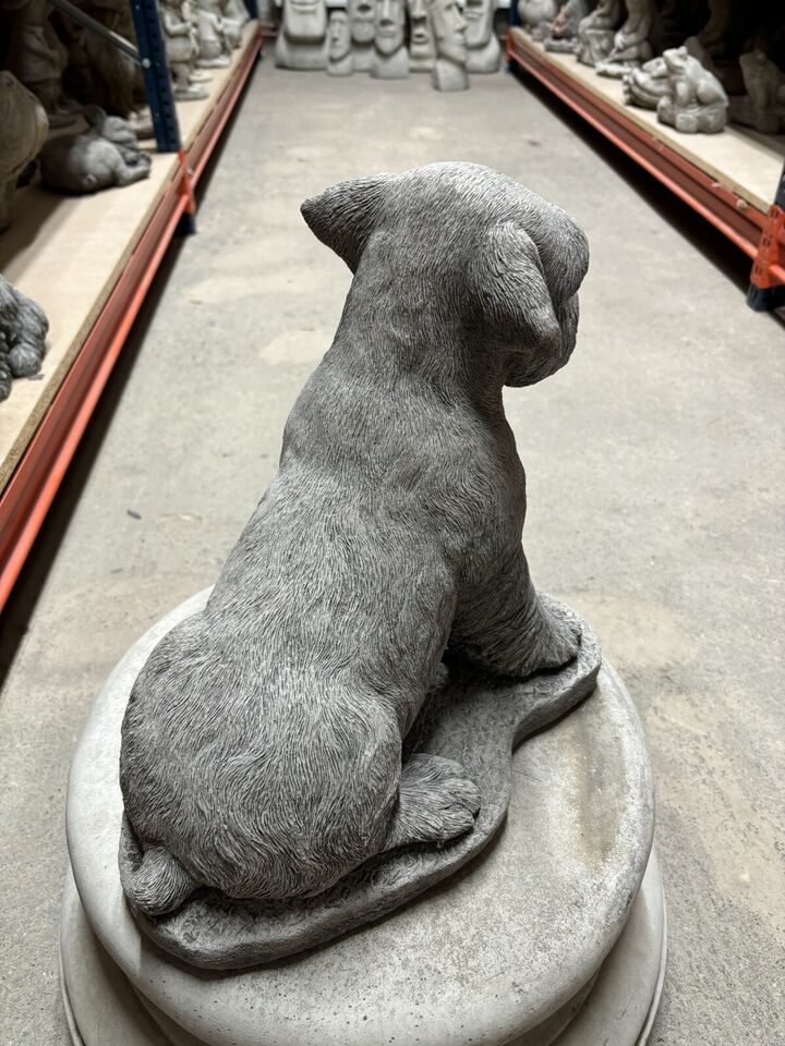 Rear view of the lifelike Stone Schnauzer Garden Statue, emphasizing its realistic form and suitability for decorative garden settings.