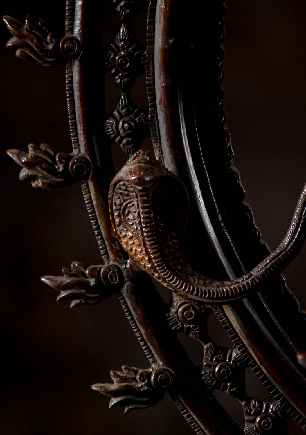 Close-up of serpent detail on halo of Brass Dancing Shiva Statue - Cosmic Art | Timeless Symbol 27", emphasizing mythological symbolism.
