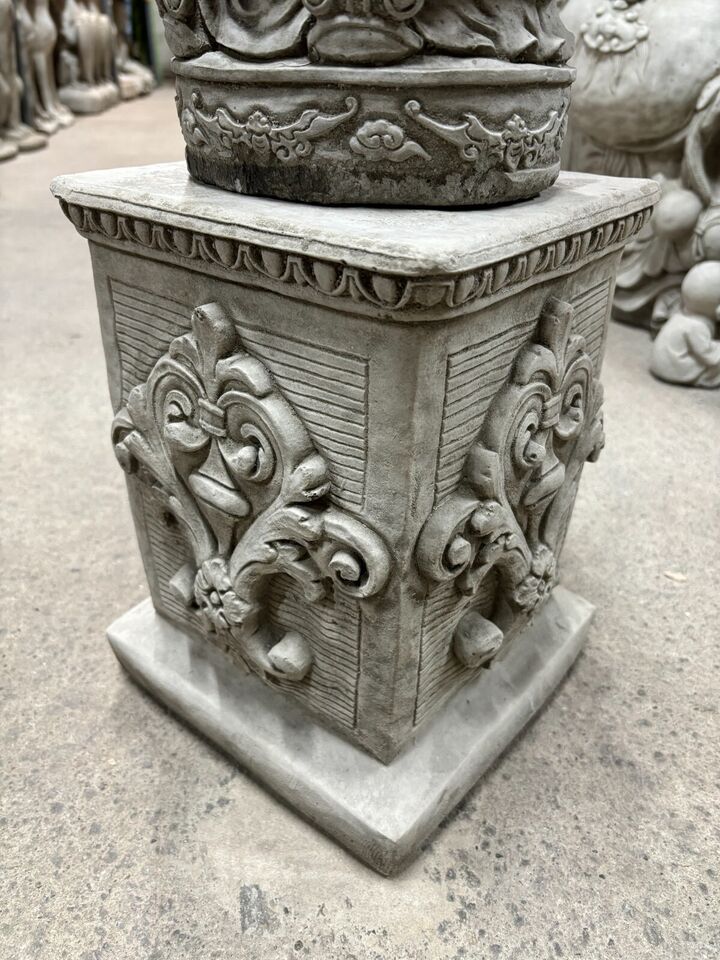 Detailed view of the antique-style plinth base with floral carvings supporting the Stone God of Longevity statue, made for outdoor display.