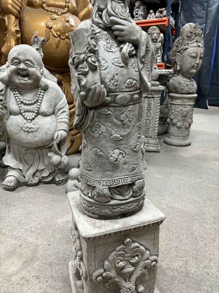 Side profile of the Stone God of Longevity statue with scroll and ornate robe, set on a carved plinth for elegant garden decoration.