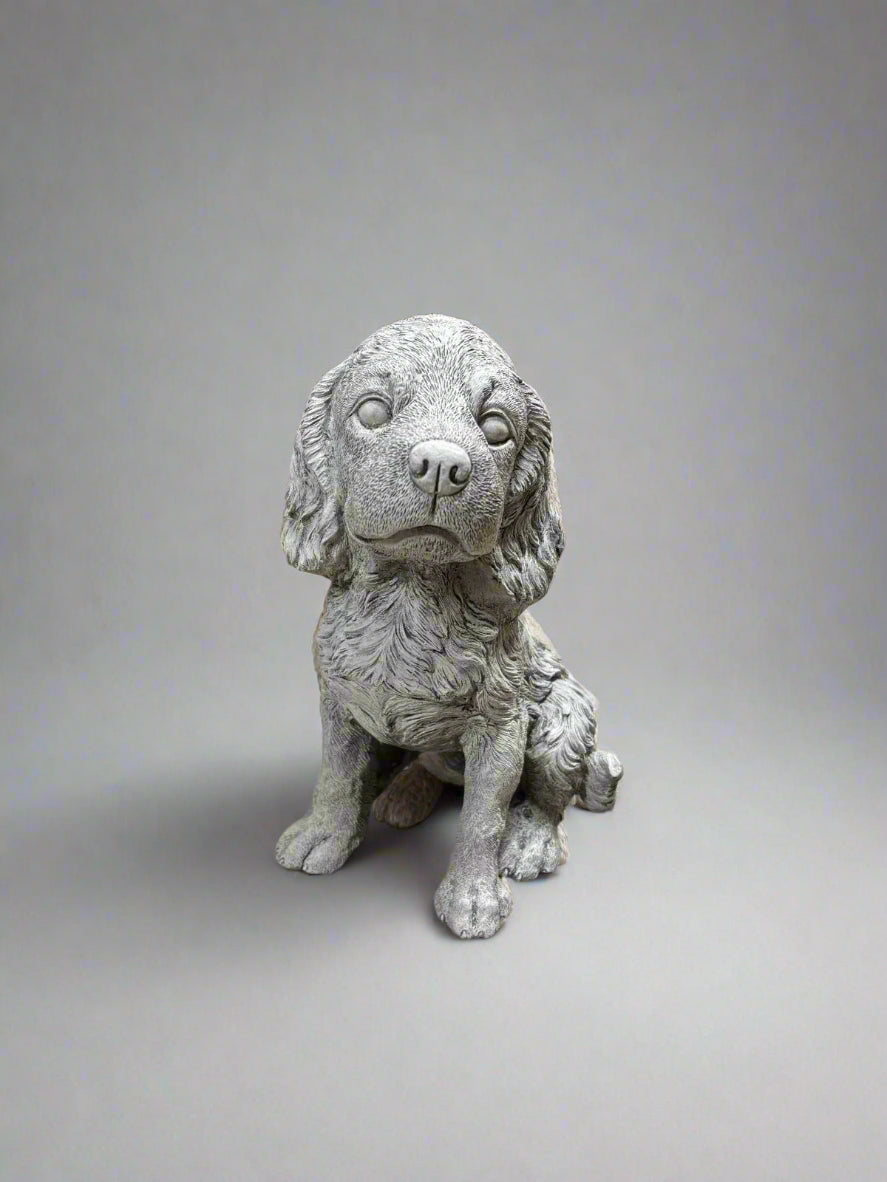 Stone Spaniel Dog Statue with lifelike fur texture, perfect for adding charm and durability to any garden or outdoor decor setting.