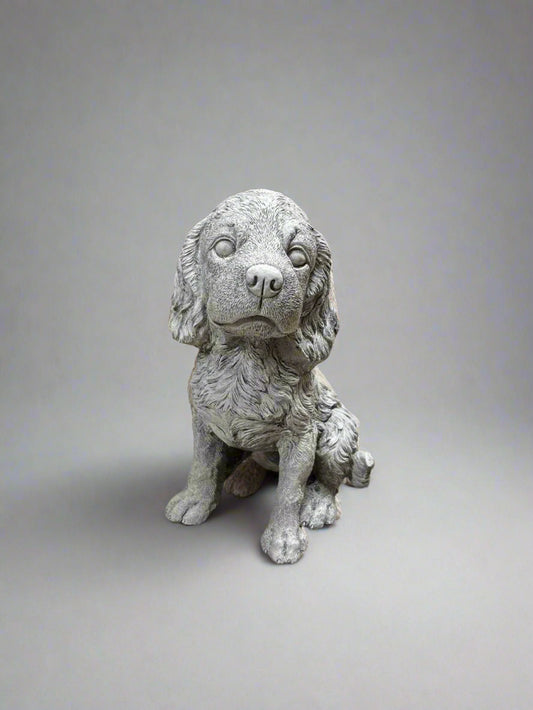 Stone Spaniel Dog Statue with lifelike fur texture, perfect for adding charm and durability to any garden or outdoor decor setting.