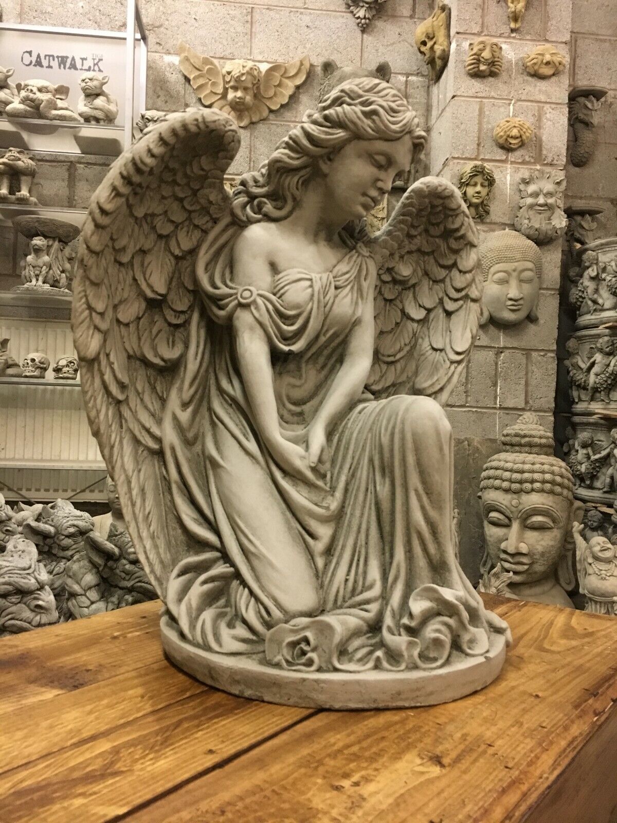Side profile of Elegant Stone Angel Garden Pedestal Statue for Landscaping. Captures the angel’s peaceful posture and finely carved wings.
