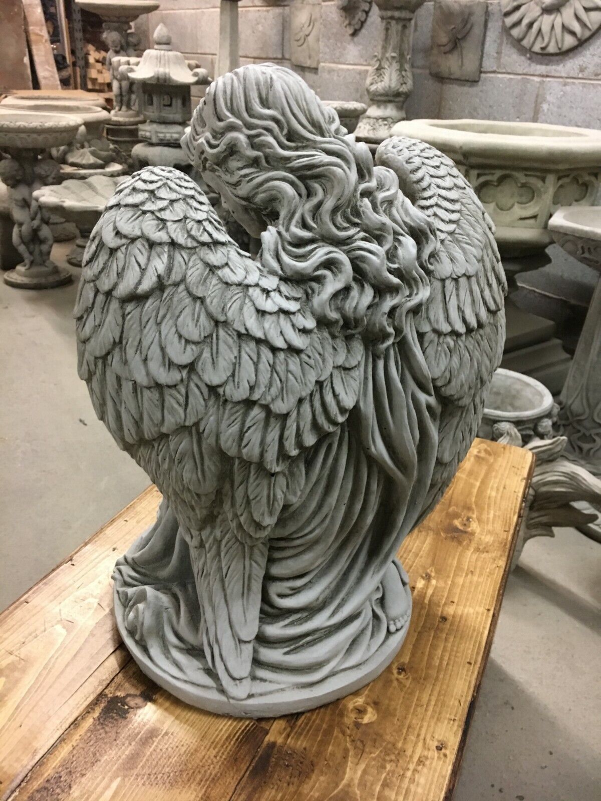 Back view of Angel Garden Pedestal Statue - Stone Finish | Large & Durable. Emphasizes realistic wing texture and flowing hair design.