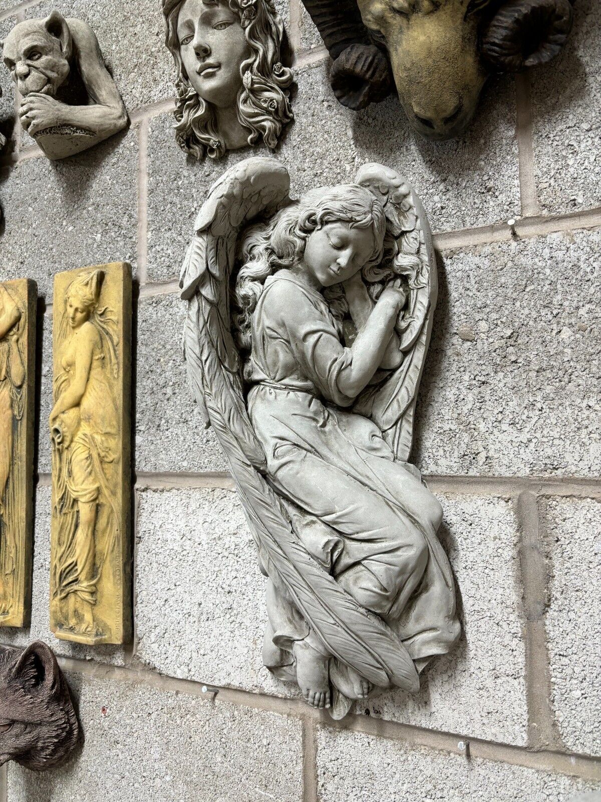 Side view of the Large Winged Angel Garden Plaque with intricate feather and robe details, ideal for outdoor decorative use.