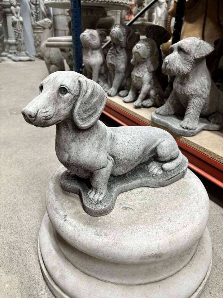 Detailed Stone Sausage Dog Garden Ornament with lifelike texture. Perfect for enhancing garden aesthetics with durable outdoor sculpture.