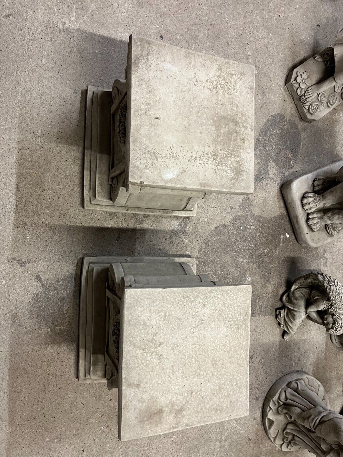 Overhead view of square stone plinths with weathered finish, designed for elegant garden sculpture or planter display.