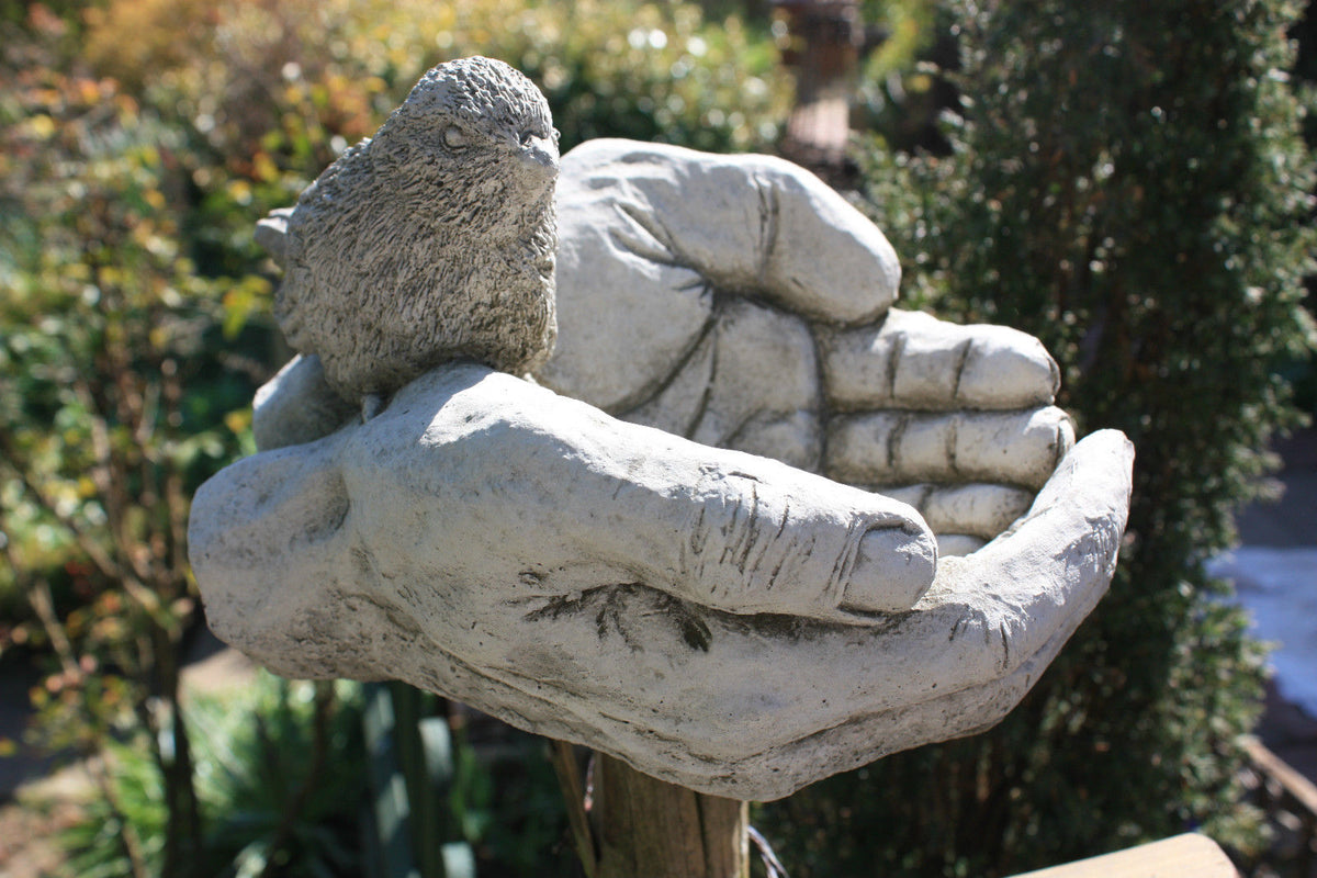 Close-up of Bird Bath/Feeder - Stone Hands Design with Durable Finish, highlighting intricate hand and bird sculpture for garden decoration.