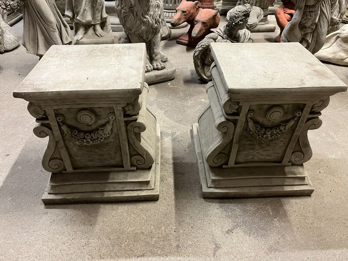 Top view of garden stone garland plinths showing flat display surface and ornate antique-style detailing for lawn ornaments.
