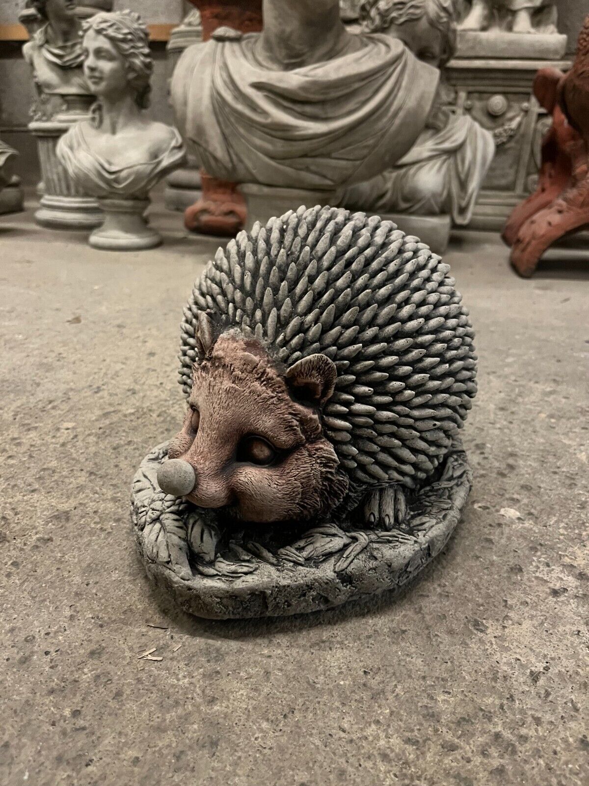 Stone Garden Hedgehog Ornament with antique grey finish, curled on a leaf base. Unique decor for outdoor garden sculpture collections.
