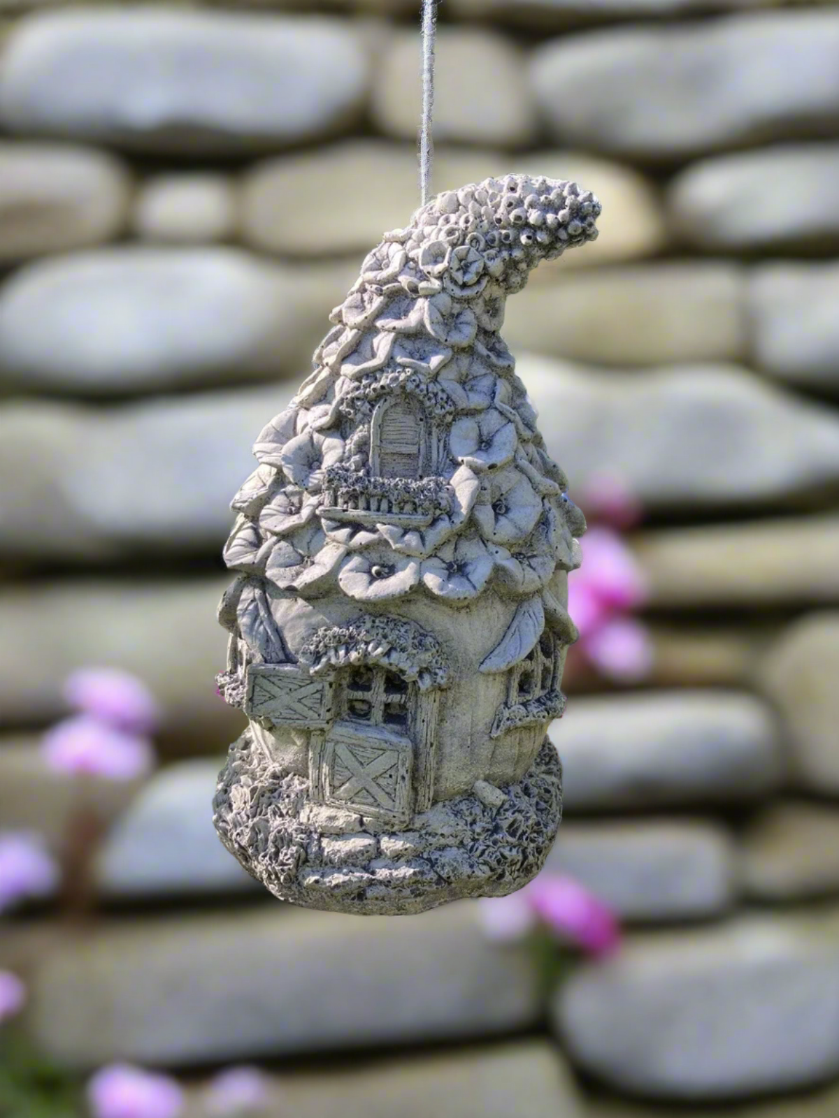 Hanging Stone Fairy Cottage garden sculpture with whimsical flower-covered roof, ideal for patios or tree branches. Durable and weatherproof design.