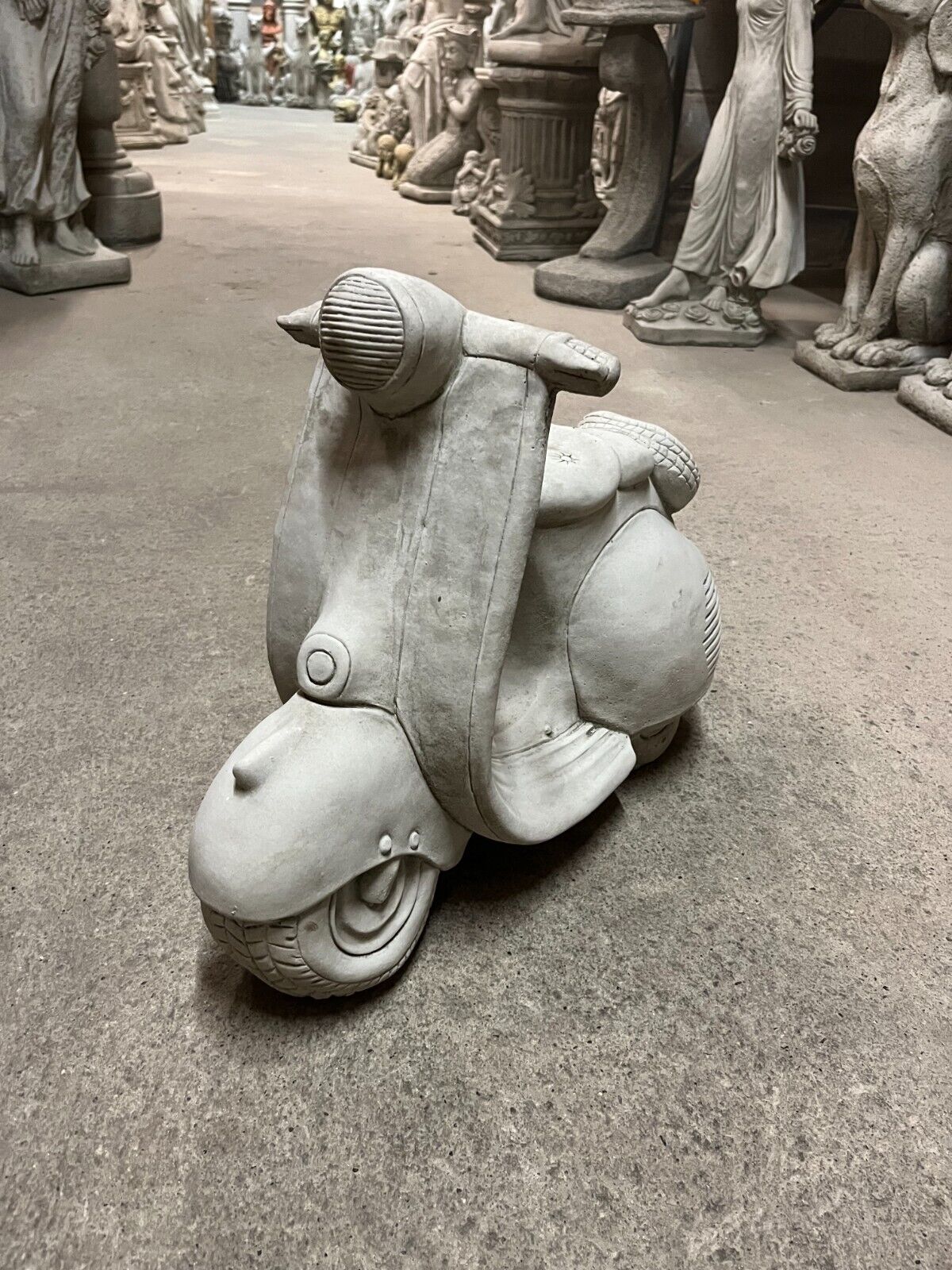 Vesper Motorbike Garden Ornament in antique stone finish, crafted from durable limestone with detailed front view, ideal for outdoor decor.