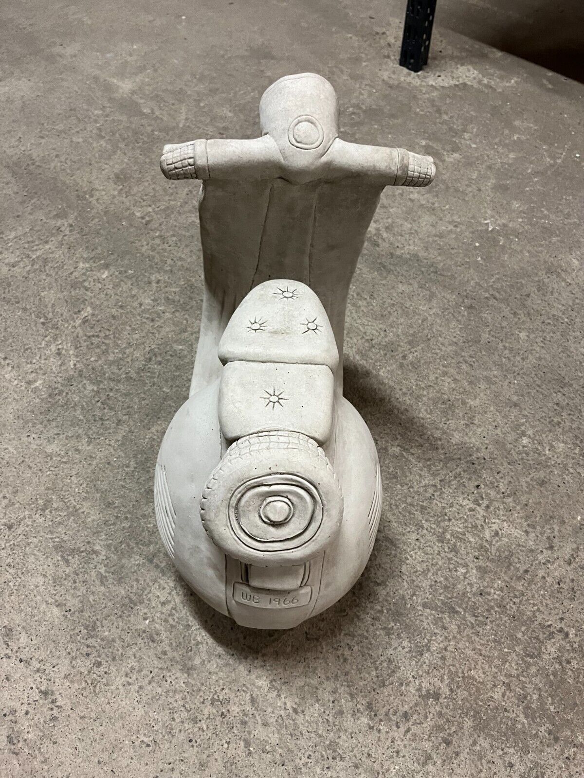 Top-down view of Vesper Motorbike Garden Ornament highlighting seat and handlebar details in solid limestone with antique stone finish.
