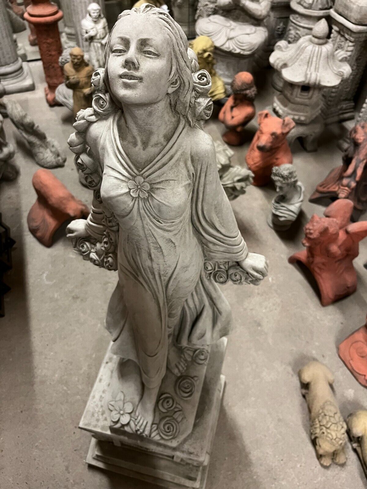 Close-up of Stone Rose Lady Garden Statue showing serene facial expression and intricate floral detailing on base and gown.