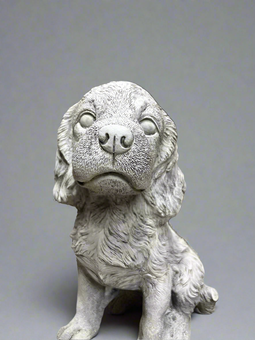 Close-up of Stone Spaniel Dog Statue's face showing fine limestone texture and expressive features for decorative garden appeal.