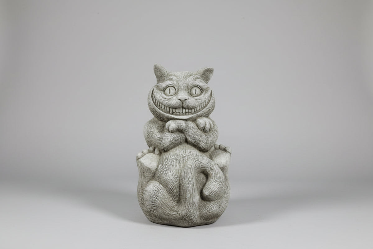 Statue of a cat with a smiling face on a white surface.