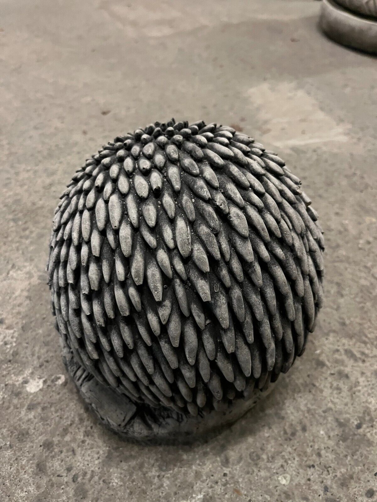 Close-up of textured spines on Stone Hedgehog Garden Ornament. Durable and weather-resistant for year-round outdoor decor.
