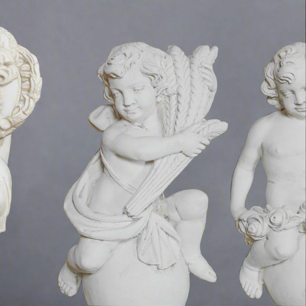 Detailed view of the Summer cherub holding wheat in the Four Seasons Stone Statues set, perfect for classical garden sculpture themes.