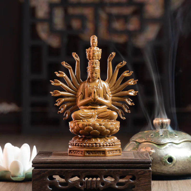 Wooden Guan Yin Meditation Statue on carved pedestal, surrounded by incense and lotus flower. Enhances peaceful ambiance.