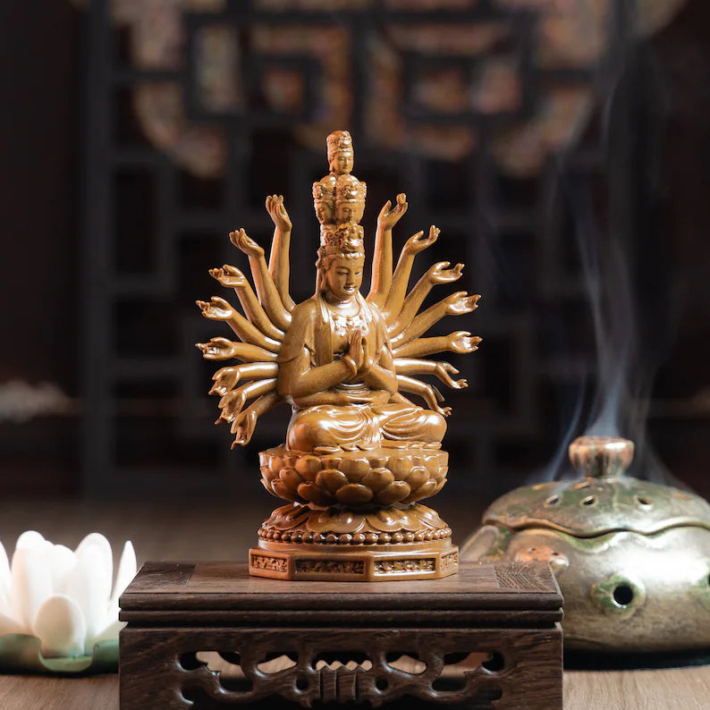 Elegant Guan Yin Wooden Statue with multiple arms, placed on altar table. A calming centerpiece for home meditation areas.