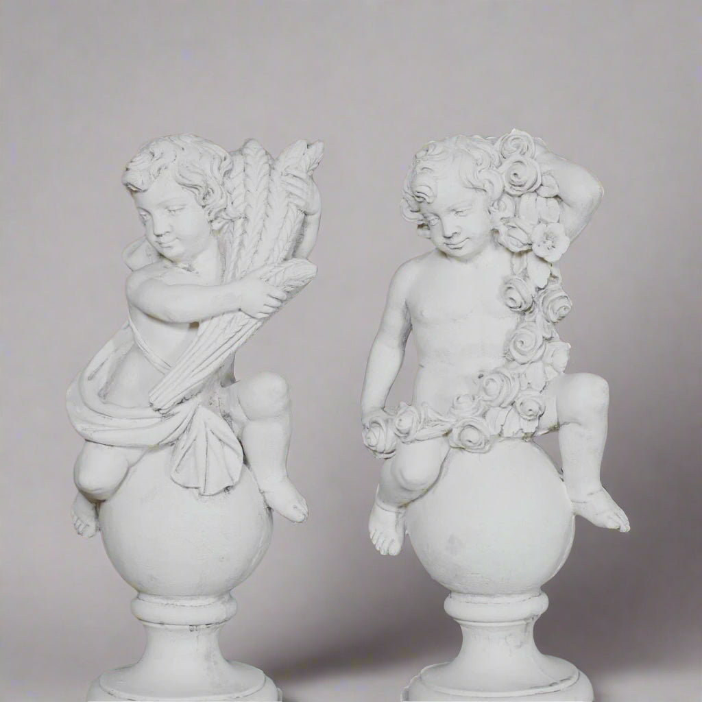 Spring and Summer cherubs from the Four Seasons Stone Statues set, hand-carved with floral and harvest motifs for elegant garden decor.