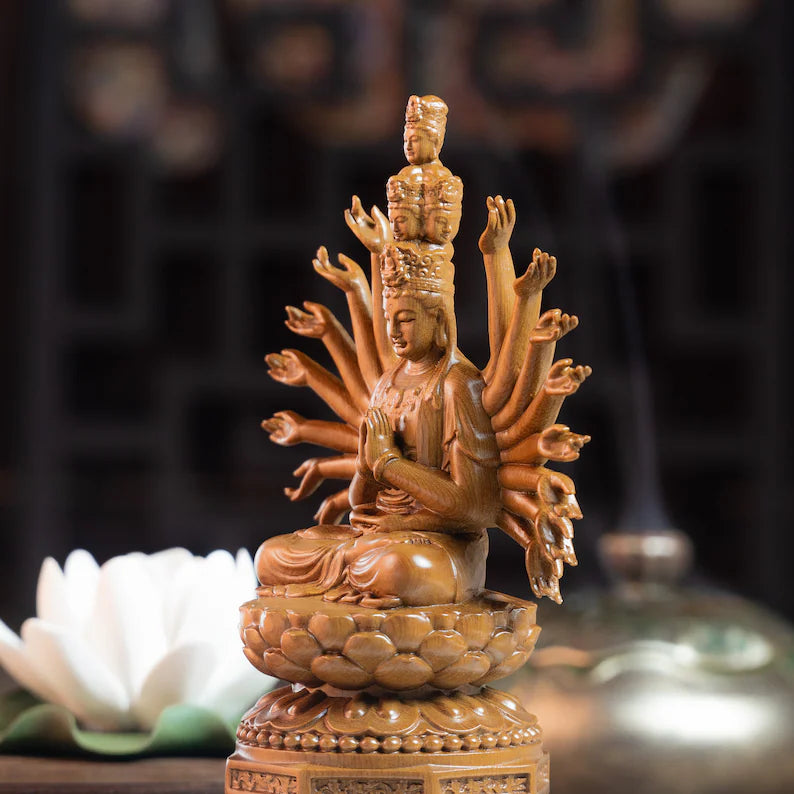 Close-up of Wooden Guan Yin Statue with serene expression and lotus seat. A spiritual ornament for peaceful home settings.