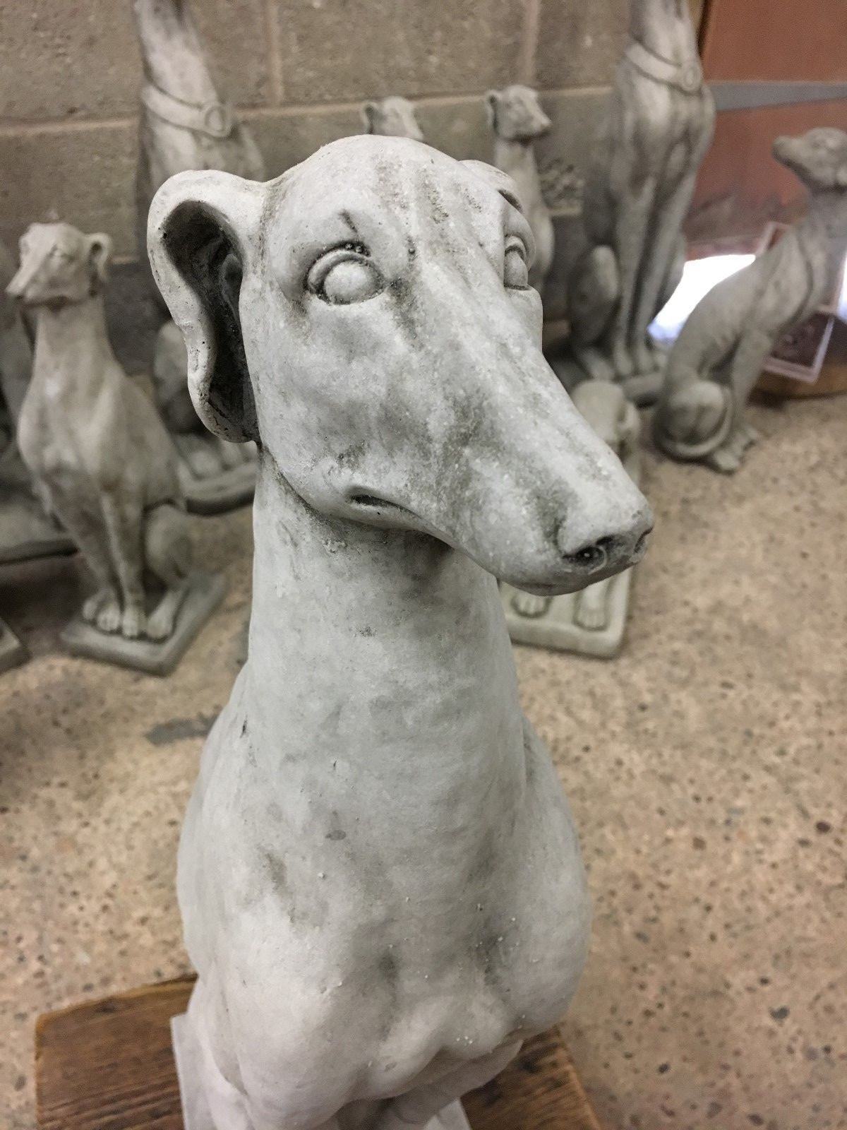 Front view of a limestone greyhound statue with realistic facial features, ideal for outdoor garden or patio decoration.